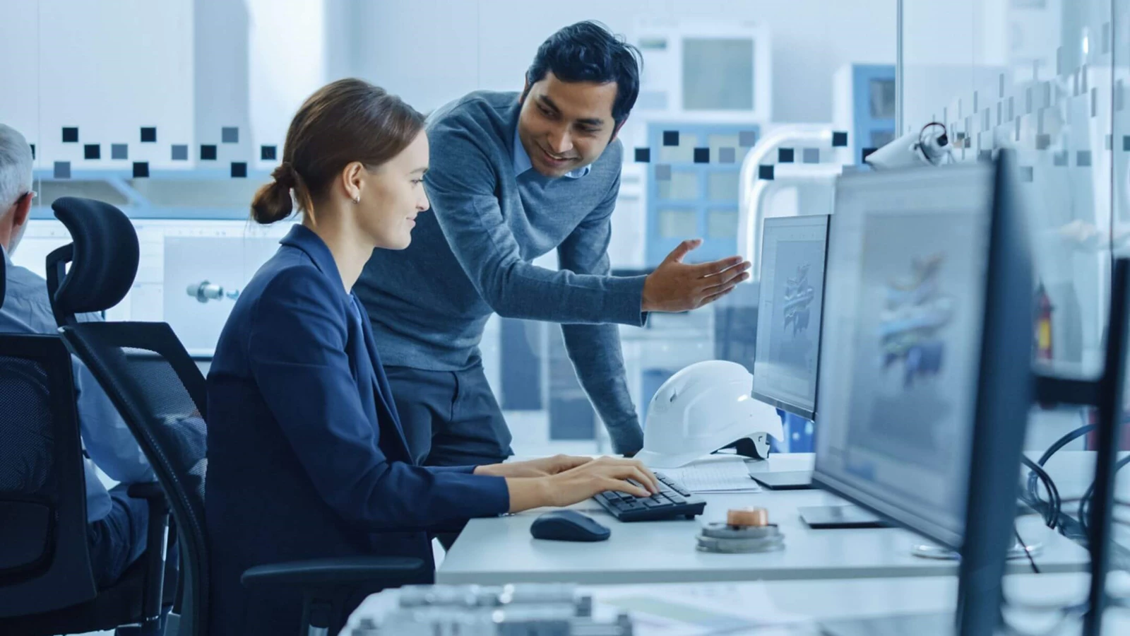 Two GM Employees collaborating at work