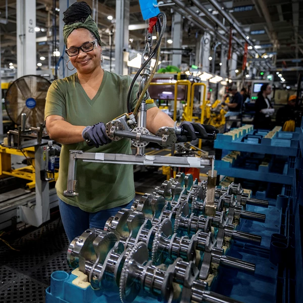 Woman in glasses working on manufacturing line