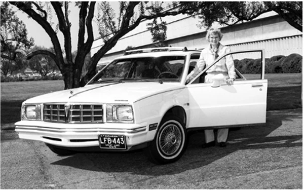 GM employee posing in front of their car